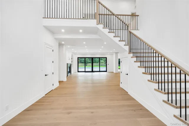a view of entryway and hall with wooden floor