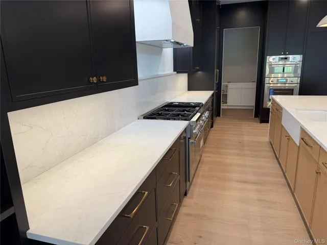 a kitchen with stainless steel appliances a refrigerator a stove and a sink