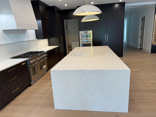 a kitchen with stainless steel appliances a stove a sink and a refrigerator