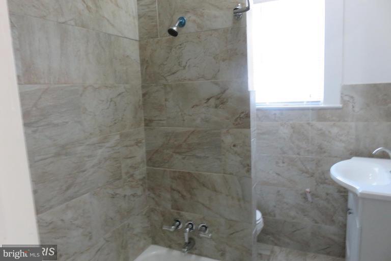 3819 Barrington Road Baltimore, MD 21215 - Photo 16 of 19 a bathroom with a shower