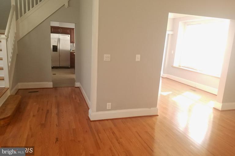 3819 Barrington Road Baltimore, MD 21215 - Photo 8 of 19 a view of a hallway with wooden floor