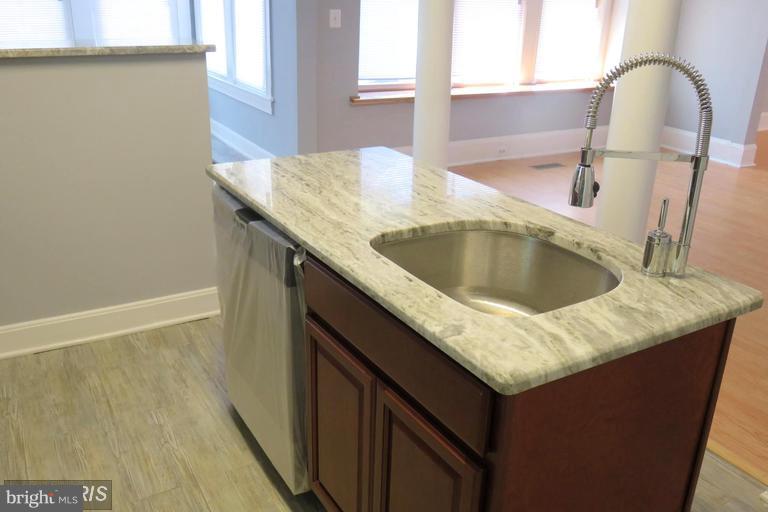 3819 Barrington Road Baltimore, MD 21215 - Photo 10 of 19 a kitchen with a granite countertop sink and a window