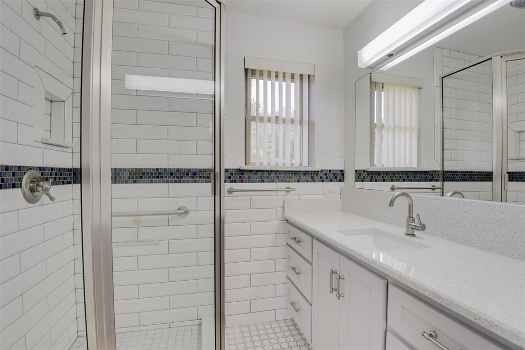 802 Cardinal Road Mansfield, TX 76063 - Photo 22 of 31 Bathroom with vanity, a stall shower, and tile walls