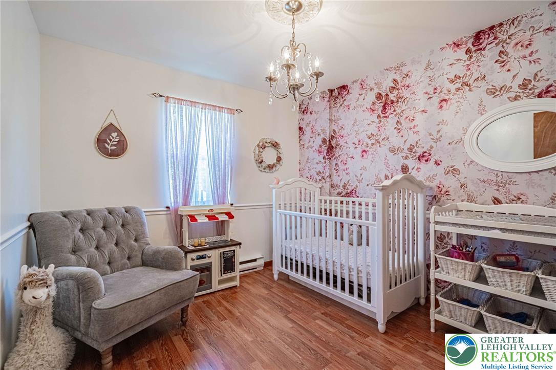 341 Lower Greenhill Road Kunkletown, PA 18058 - Photo 22 of 69 An inviting nursery features polished hardwood floors and charming floral accent wallpaper.