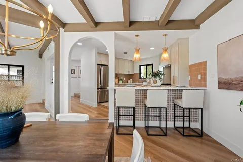 a kitchen with stainless steel appliances kitchen island granite countertop a refrigerator and cabinets