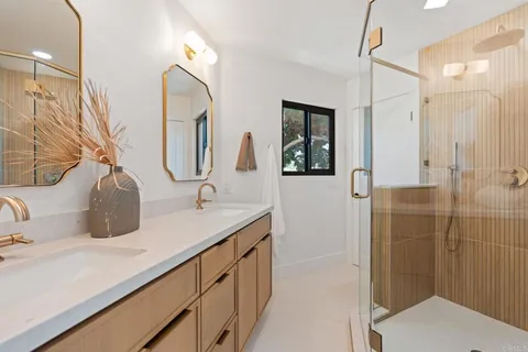 a bathroom with a sink and mirror with toilet