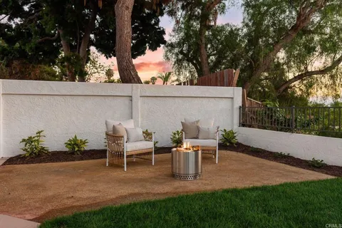 a backyard of a house with table and chairs