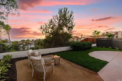 a view of backyard with seating area and green space