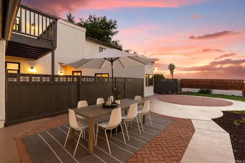 a patio with a table and chairs