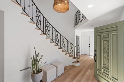 a view of entryway and hall with wooden floor