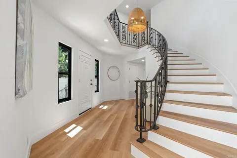 a view of entryway and hall with wooden floor