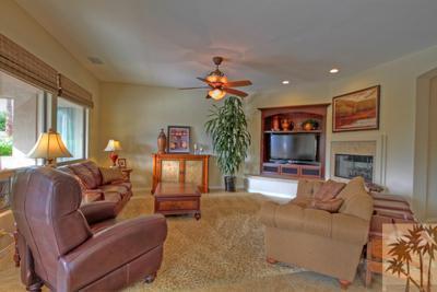 81129 Soaring Hawk Court Indio, CA 92201 - Photo 11 of 25 a living room with furniture a chandelier and a fireplace