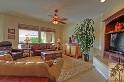 81129 Soaring Hawk Court Indio, CA 92201 - Photo 12 of 25 a living room with furniture a large window and a flat screen tv