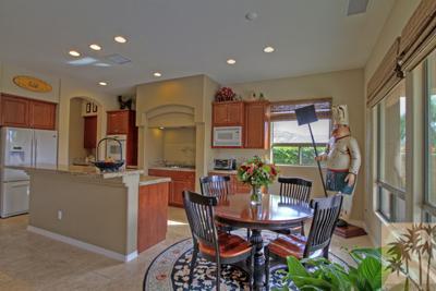 81129 Soaring Hawk Court Indio, CA 92201 - Photo 14 of 25 a dining room with furniture and a floor to ceiling window