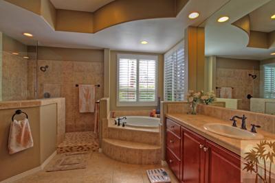 81129 Soaring Hawk Court Indio, CA 92201 - Photo 19 of 25 a spacious bathroom with a double vanity sink a mirror and a bathtub
