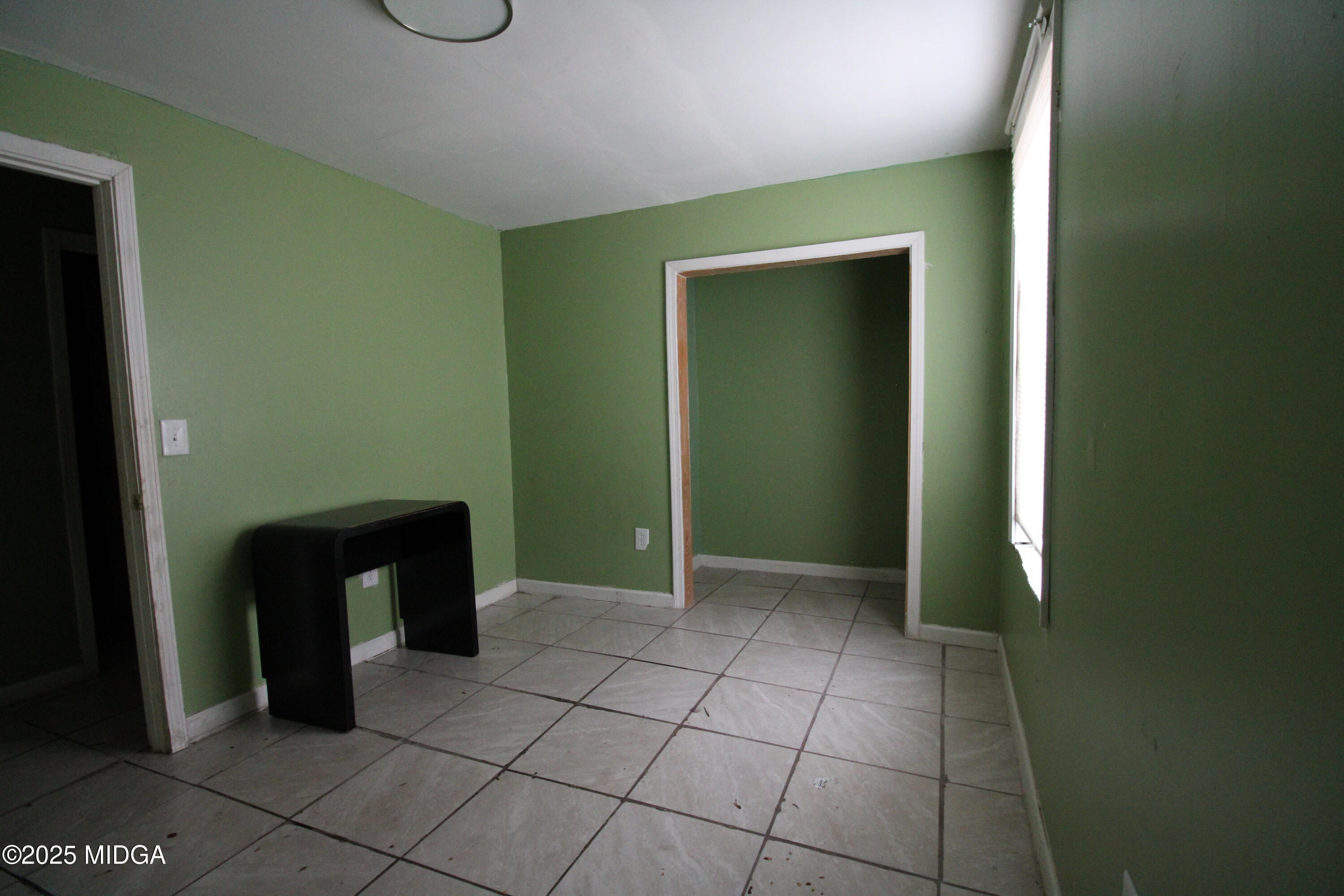 769 Bowman Street Macon, GA 31217 - Photo 6 of 12 an empty room with windows