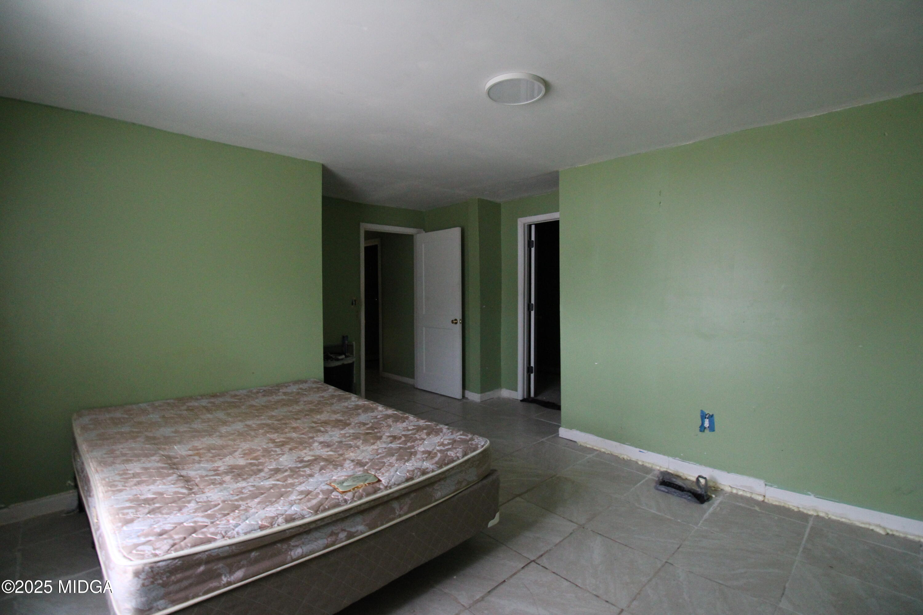 769 Bowman Street Macon, GA 31217 - Photo 7 of 12 a bedroom with a bed and closet