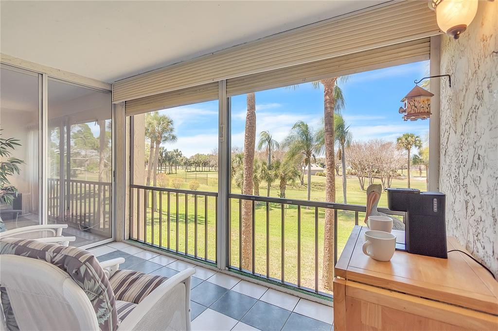 12200 Vonn Road, Unit 2206 Largo, FL 33774 - Photo 21 of 60 a bed sitting in a bedroom next to a large window