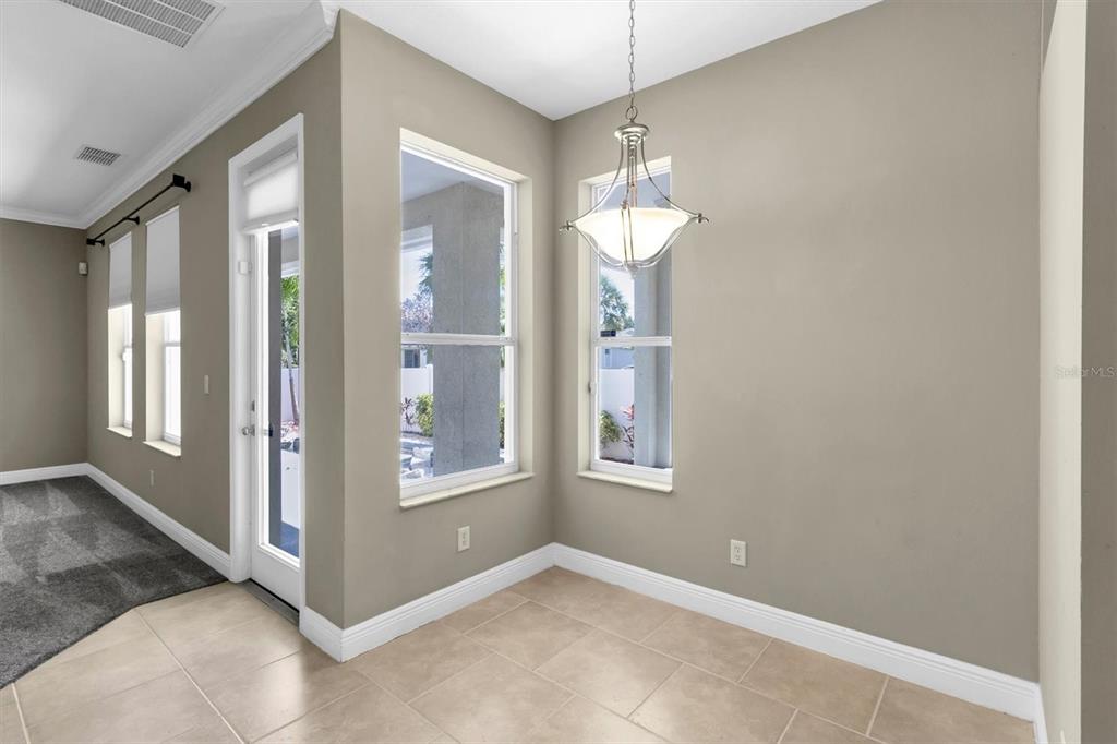 10121 Porch Street New Port Richey, FL 34655 - Photo 15 of 57 a view of a big room with chandelier fan and windows