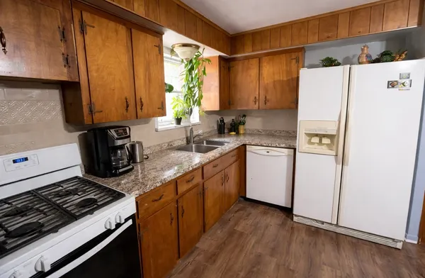 a kitchen with a sink stove and refrigerator