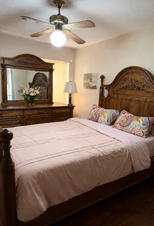 a bedroom with a bed and a chandelier