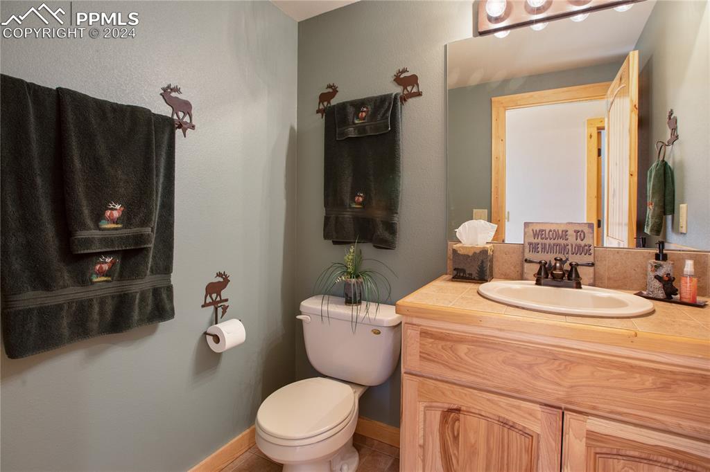 156 Paradiso Road Divide, CO 80814 - Photo 26 of 45 a bathroom with a toilet a sink and mirror