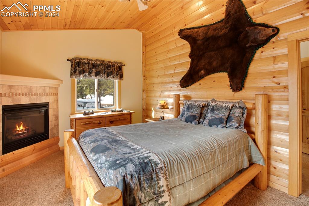 156 Paradiso Road Divide, CO 80814 - Photo 29 of 45 a bedroom with a bed and a fireplace