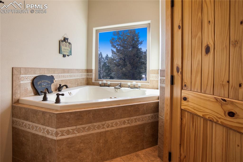 156 Paradiso Road Divide, CO 80814 - Photo 32 of 45 a bathroom with a bathtub and a shower