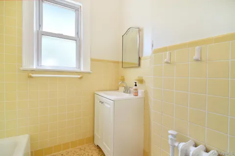 a bathroom with a sink a mirror and a shower