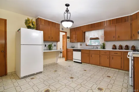 a kitchen with a refrigerator a stove top oven and cabinets