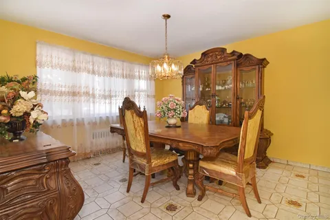 a view of a dining room with furniture and chandelier