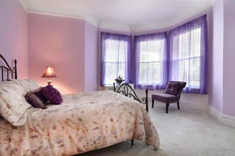 a bedroom with a bed and a windows