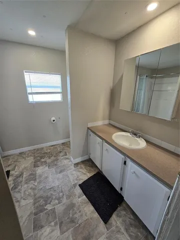 a bathroom with a sink toilet and mirror