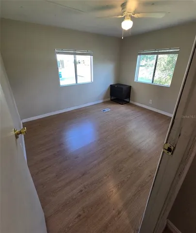 a view of walk in closet with empty racks