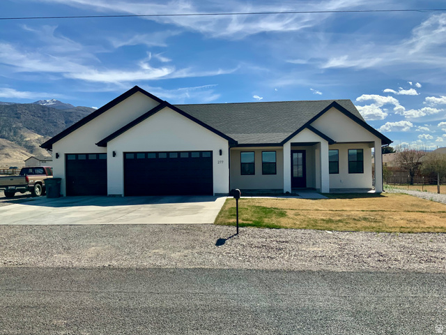 277 West 800 South Monroe, UT 84754 - Photo 1 of 46 Modern farmhouse style home with driveway, a shingled roof, an attached garage, stucco siding, and a front lawn