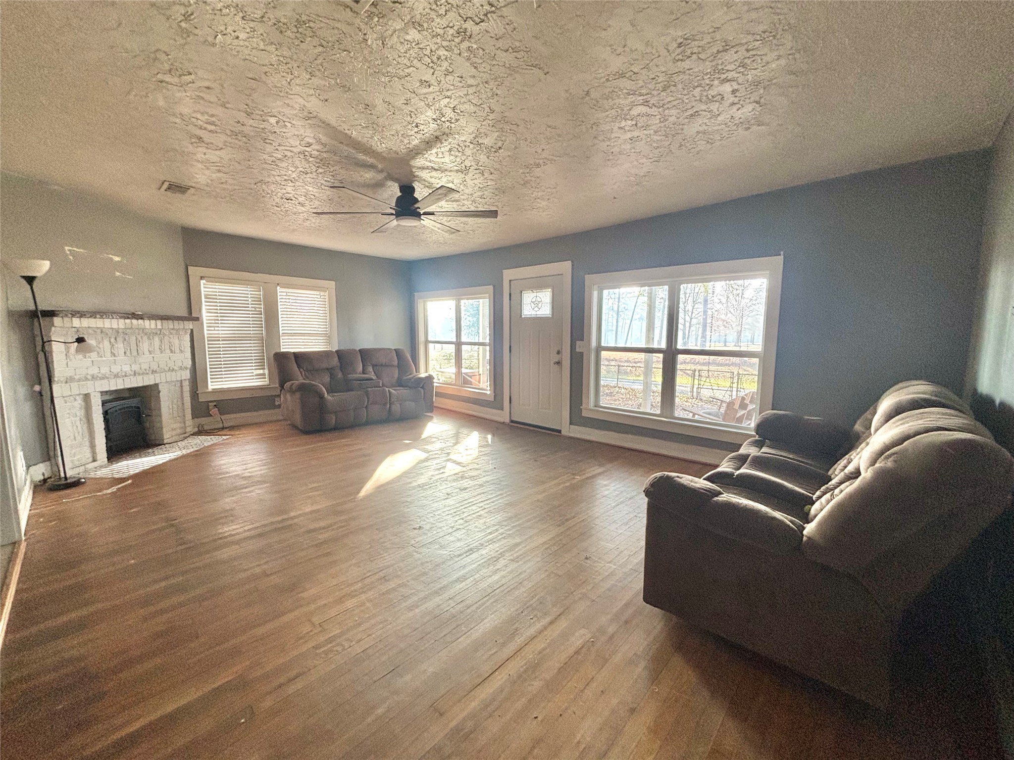 408 West Elder Street Colmesneil, TX 75938 - Photo 11 of 28 a living room with furniture or couch and a fireplace