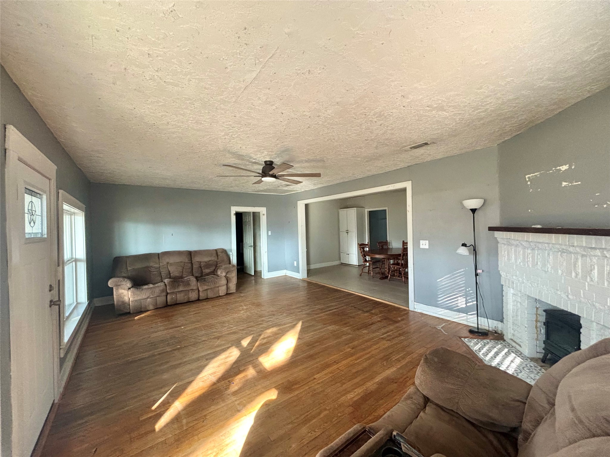 408 West Elder Street Colmesneil, TX 75938 - Photo 12 of 28 a bedroom with furniture and a fireplace
