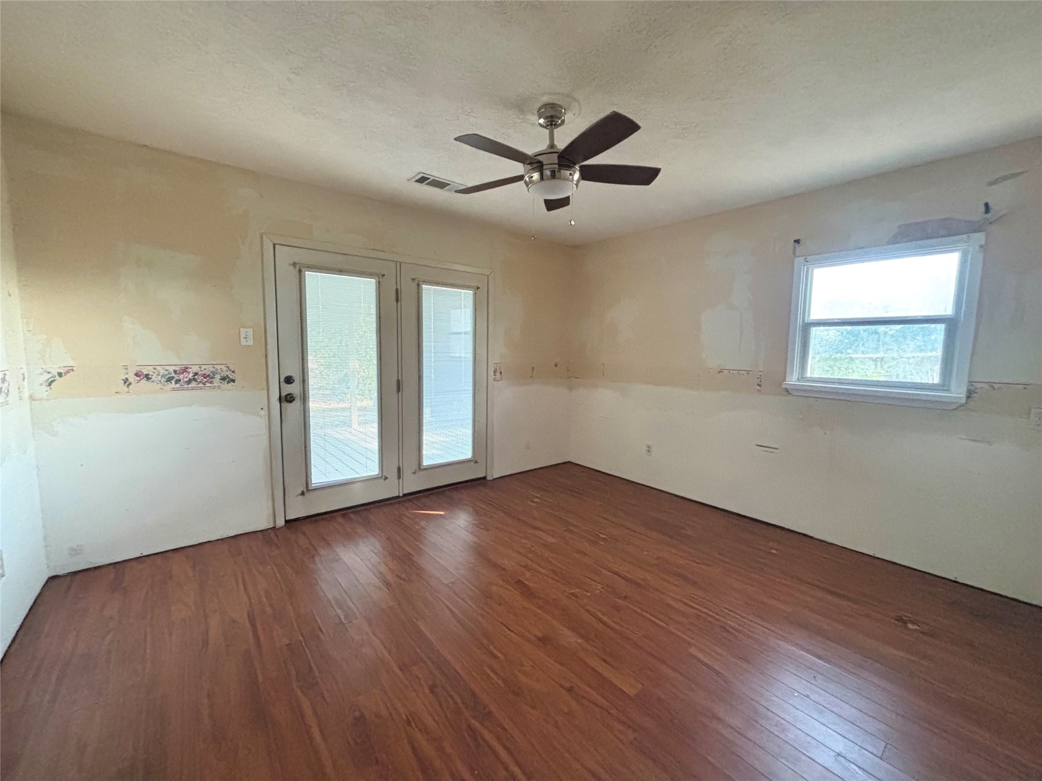 408 West Elder Street Colmesneil, TX 75938 - Photo 16 of 28 a view of an empty room with wooden floor and a window