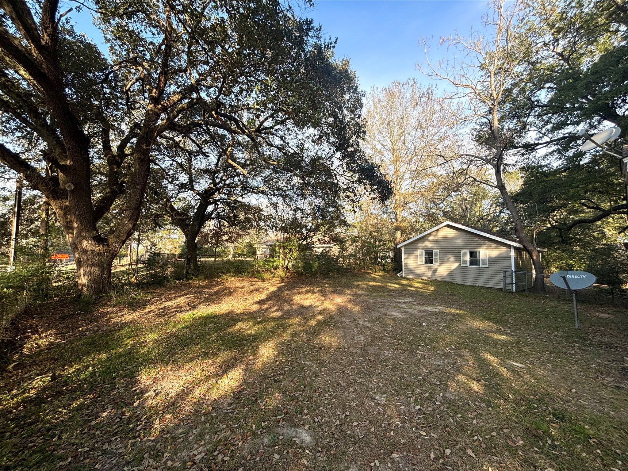 408 West Elder Street Colmesneil, TX 75938 - Photo 7 of 28 a view of a large house with a big yard and large tree