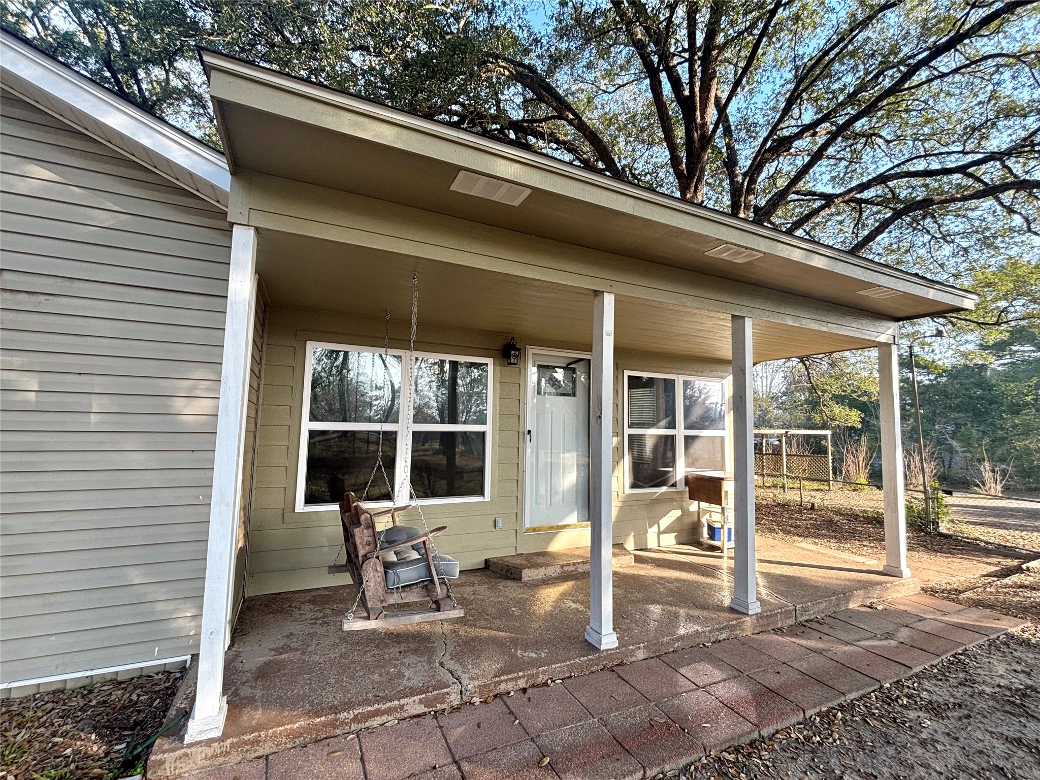 408 West Elder Street Colmesneil, TX 75938 - Photo 8 of 28 a view of a patio with table and chairs and floor to ceiling window