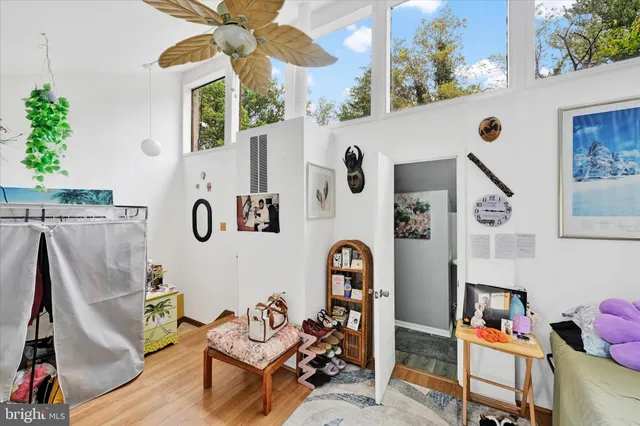 a living room with furniture and a floor to ceiling window