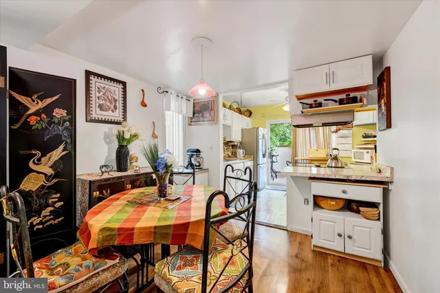 a dining room with furniture and wooden floor