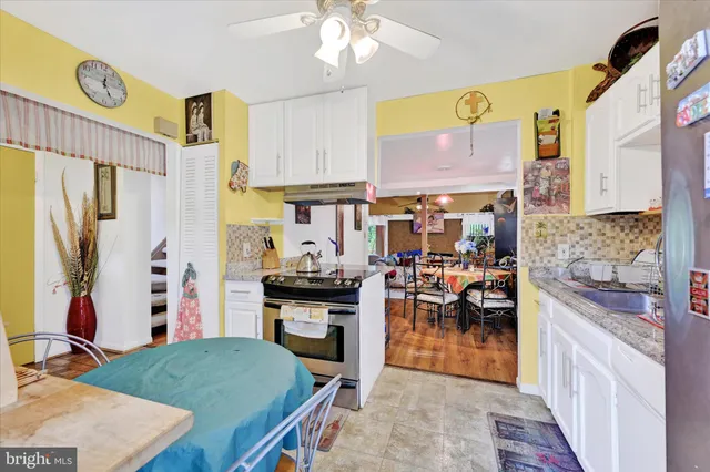 a kitchen with stainless steel appliances granite countertop a stove refrigerator and a stove