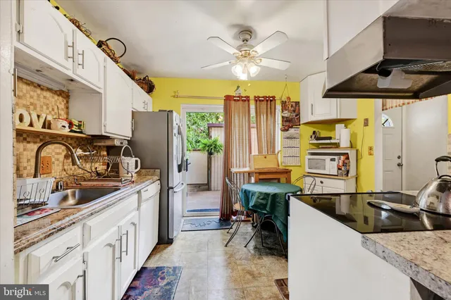 a kitchen with stainless steel appliances a stove a sink and a refrigerator