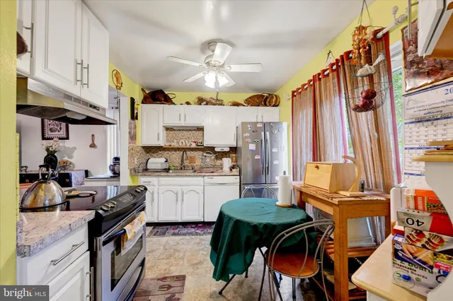 a kitchen with stainless steel appliances kitchen island granite countertop a sink and cabinets