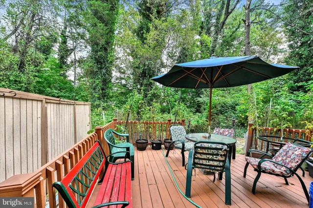 a view of an outdoor sitting area with furniture and wooden deck