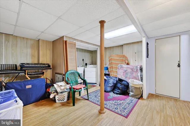 a living room with furniture a rug and gym equipment