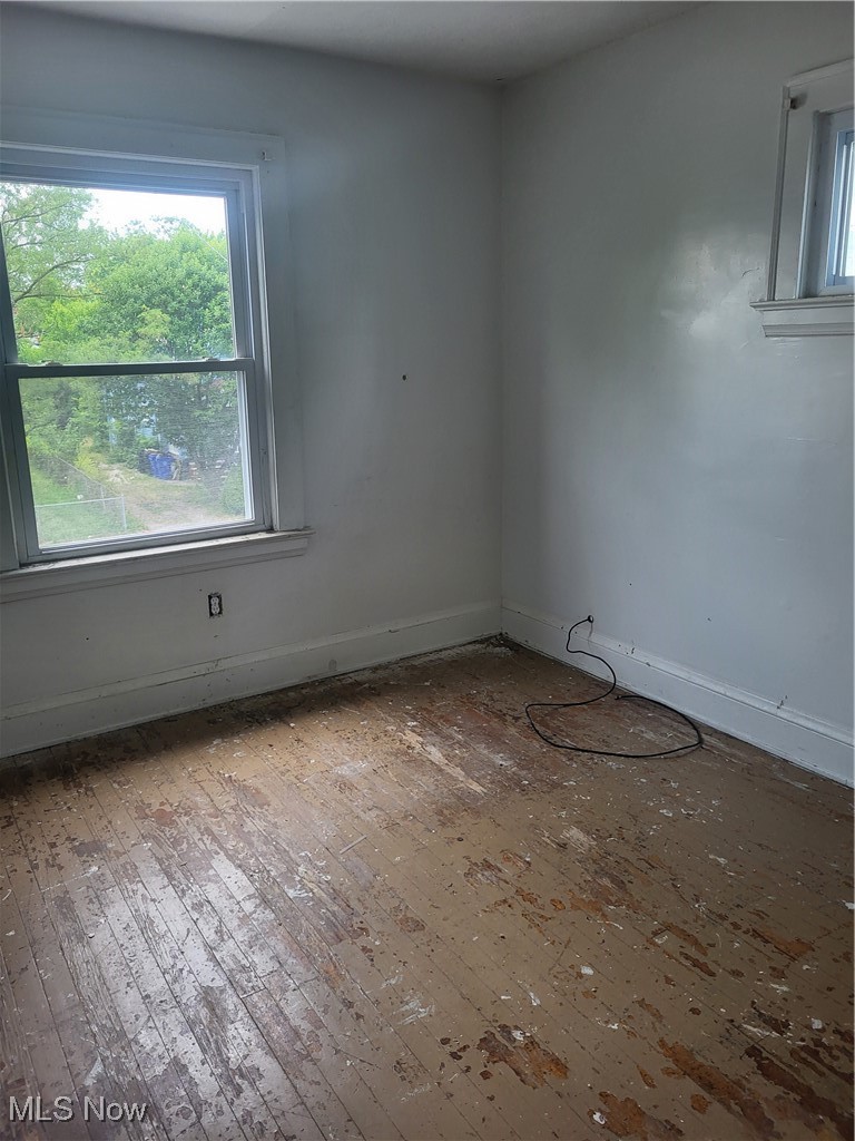 3201 East 118th Street Cleveland, OH 44120 - Photo 6 of 13 Unfurnished room featuring wood-type flooring