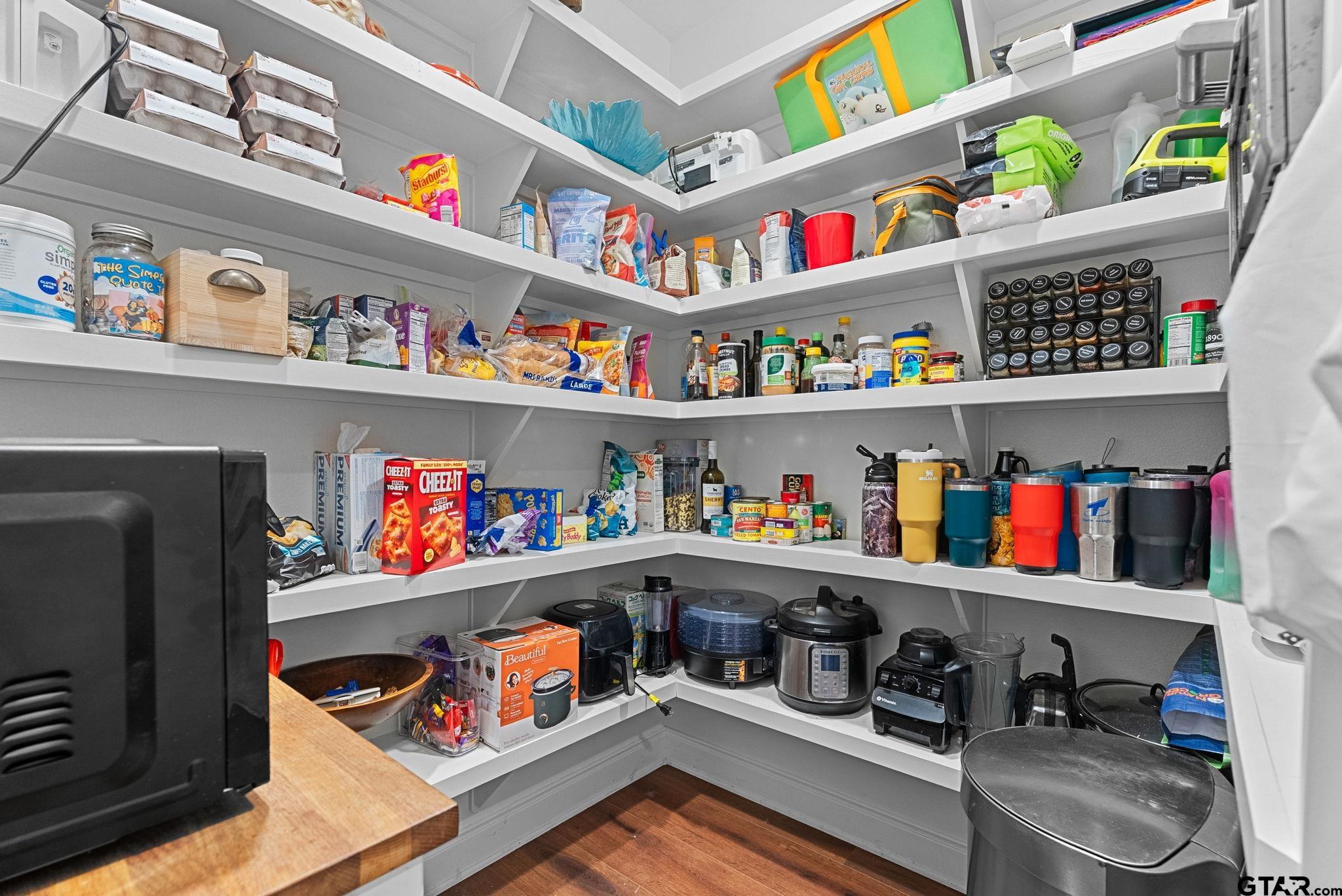 10374 Highway 204 Cushing, TX 75760 - Photo 13 of 28 a room with fridge and a painting on the wall