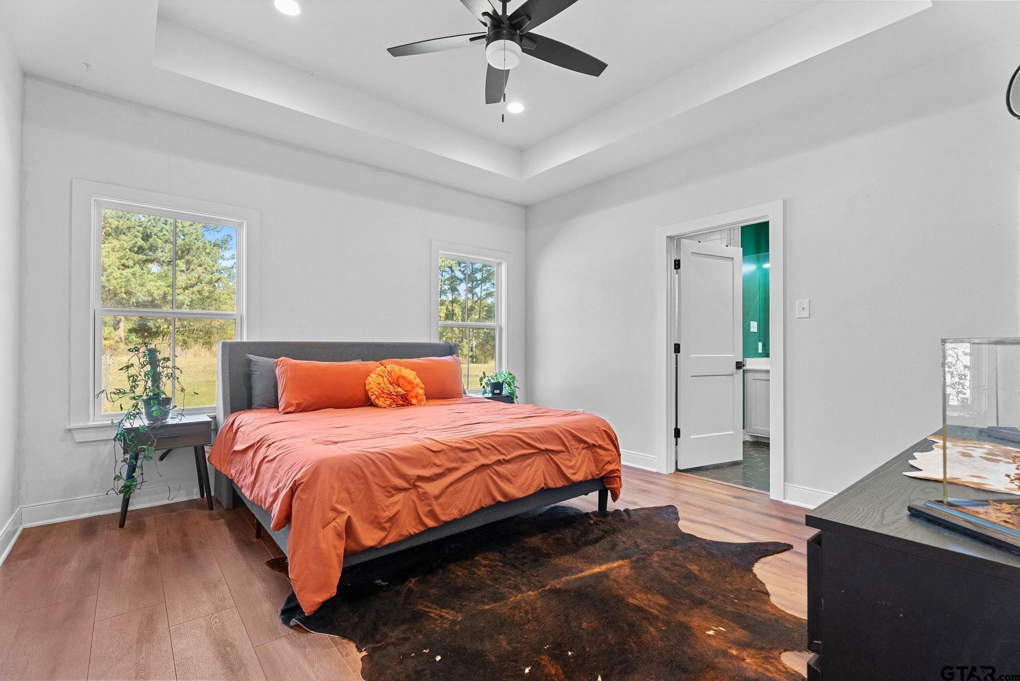 10374 Highway 204 Cushing, TX 75760 - Photo 14 of 28 a bedroom with a bed and a chandelier